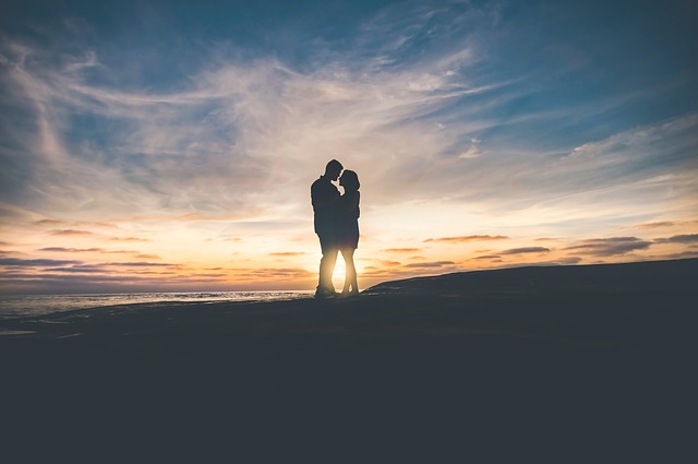 Love couple kissing each other while the sun rise